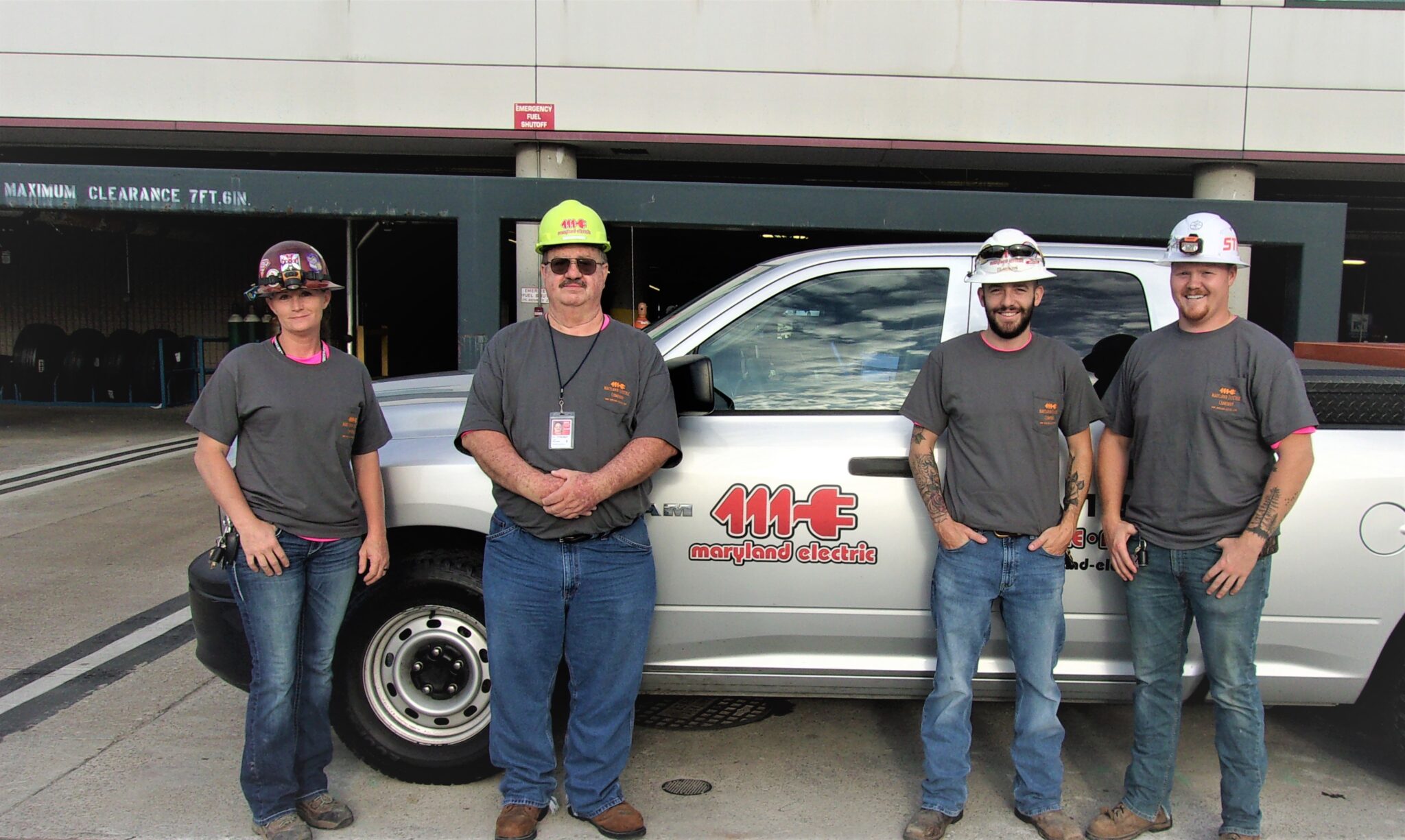 Group of Maryland Electric employees standing in front of a MECO truck